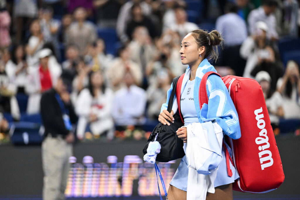 Qinwen Zheng leaves the court at the China Open.