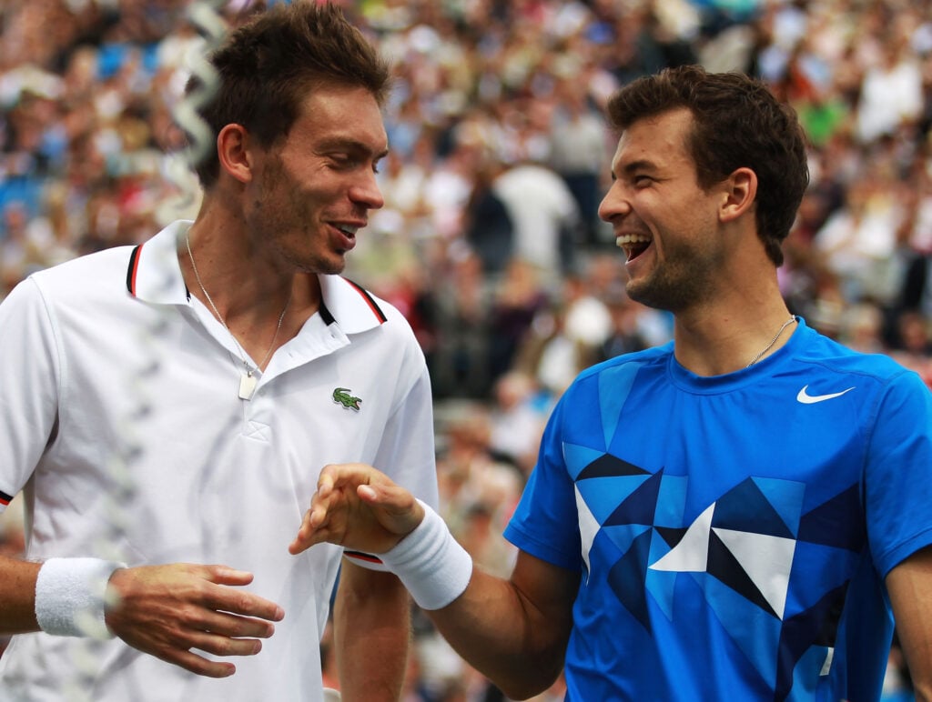 Grigor Dimitrov of Bulgaria shakes hands with Nicolas Mahut of France after defeating him in mens singles third round match against on day four of the AEGON Championships at Queens Club.