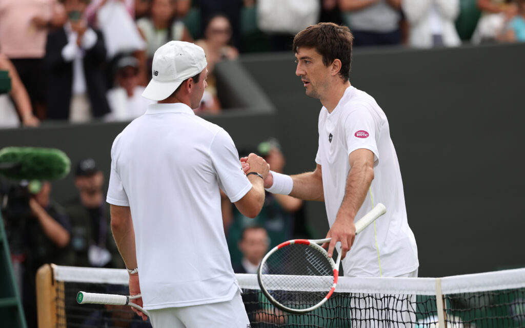 Tommy Paul shakes hands with Sebastian Ofner after losing to him at Wimbledon in 2025.