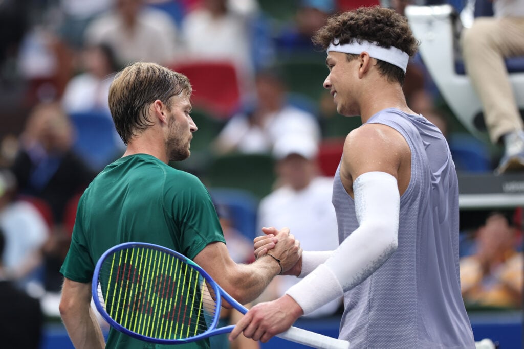 David Goffin and Ben Shelton shake hands at the net after their match in Shanghai.