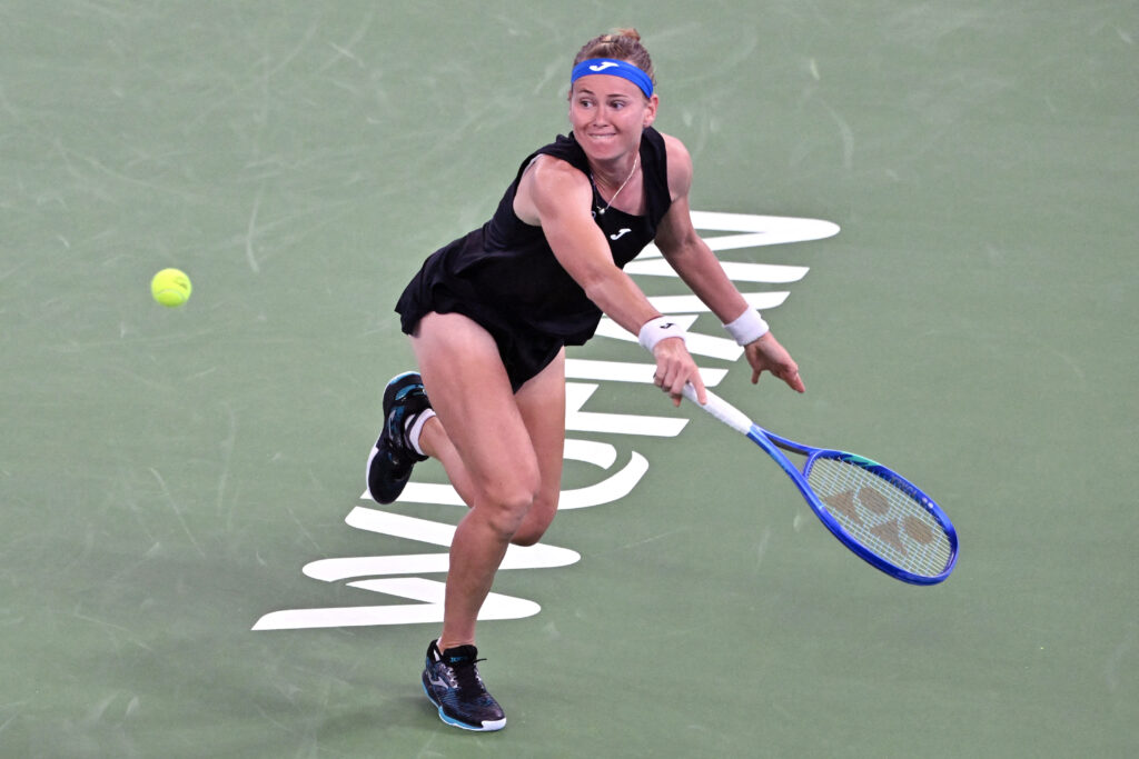 Marie Bouzkova stretches for a shot against Iga Swiatek at the 2025 Wuhan Open