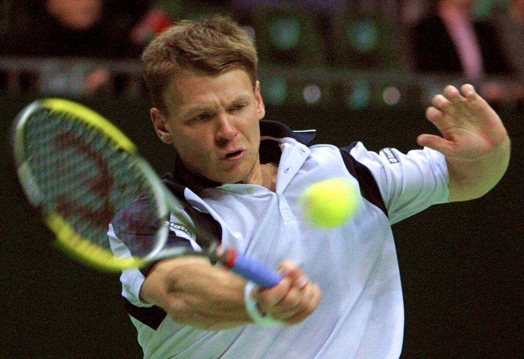 Vladimir Voltchkov makes a return at the 2004 Davis Cup