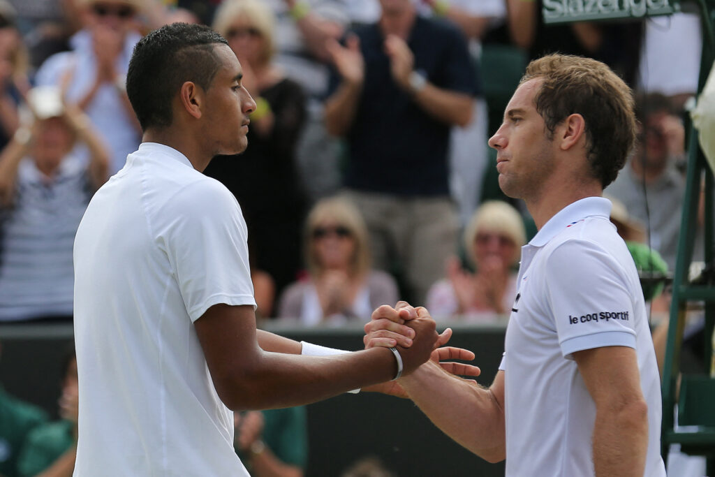 Nick Kyrgios shakes hands with Richard Gasquet after he won their men's singles second round match on day four of the 2014 Wimbledon Championships.