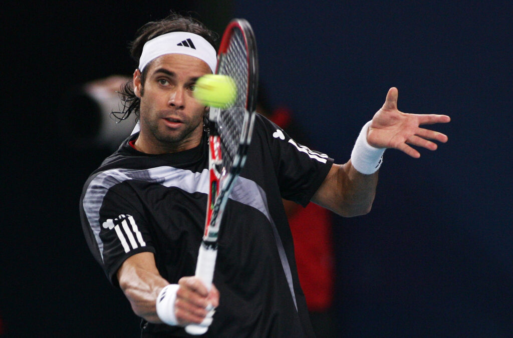 Fernando Gonzalez of Chile returns a shot against Marat Safin of Russia in his second round match during day seven of the 2009 China Open at the National Tennis Centre.