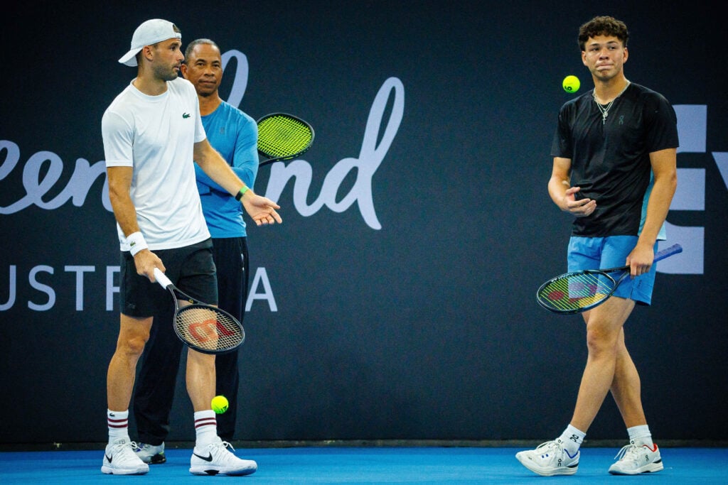 Grigor Dimitrov and Ben Shelton stand beside one another at the back of the court