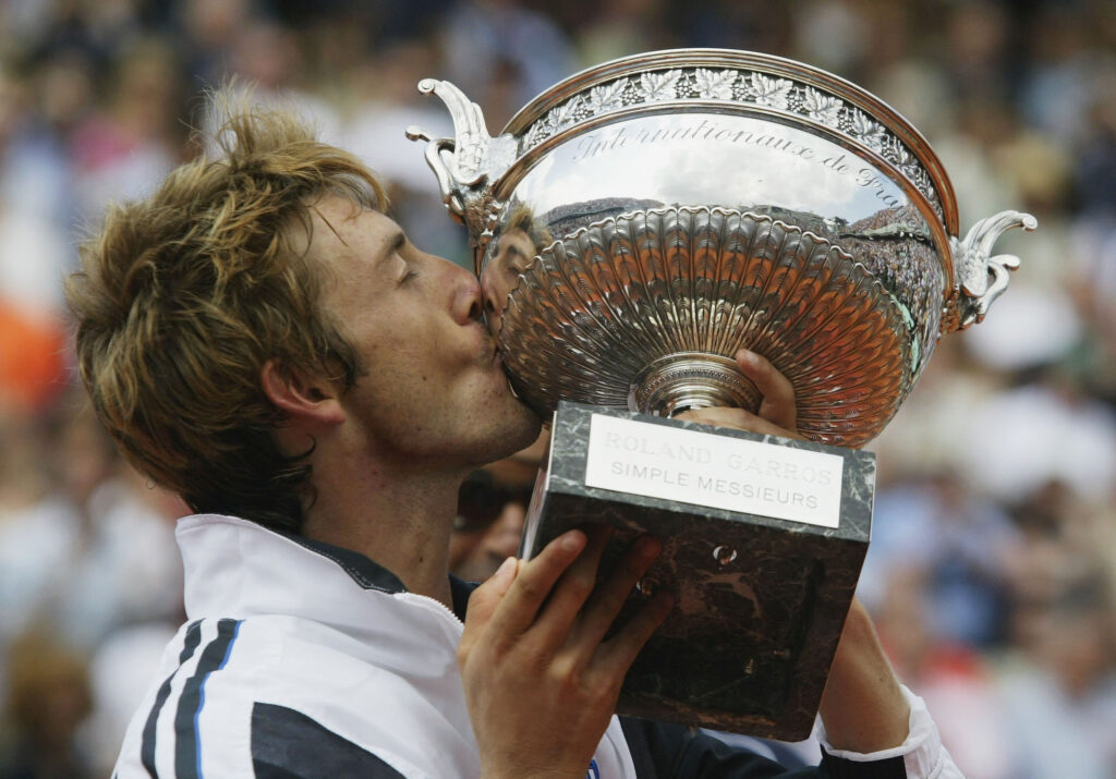 Juan Carlos Ferrero kisses the French Open trophy after winning the title in 2003.