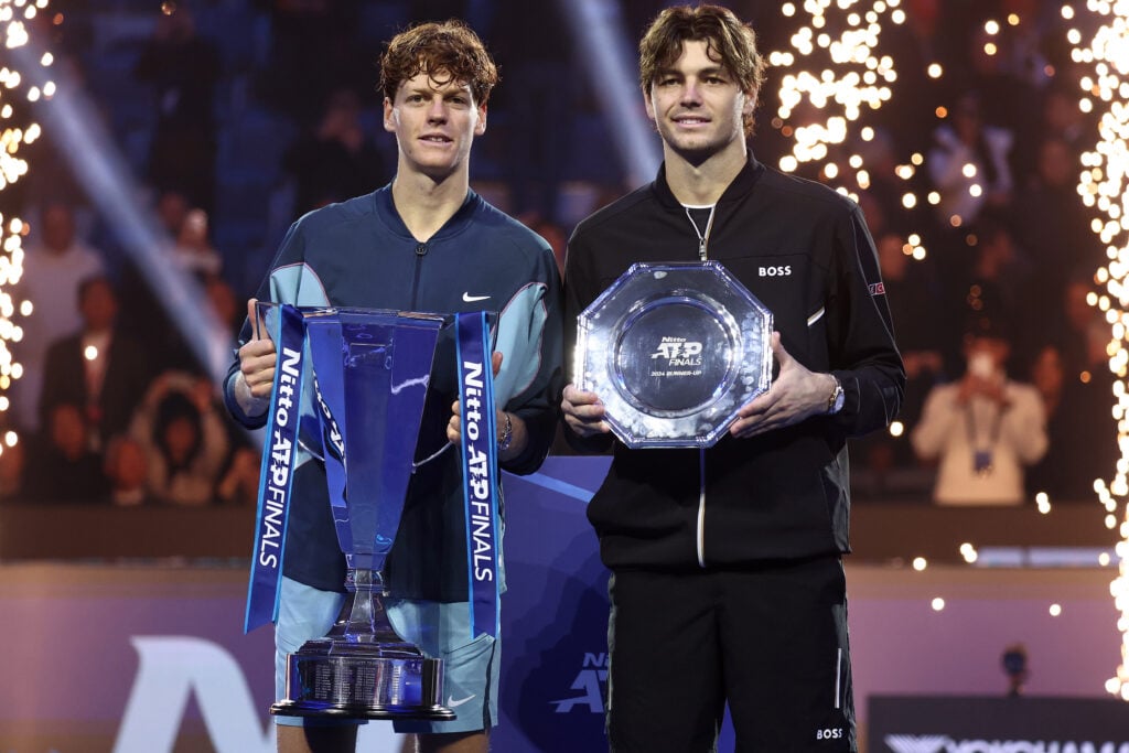 Jannik Sinner and Taylor Fritz pose with the ATP Finals winner and runners-up trophy