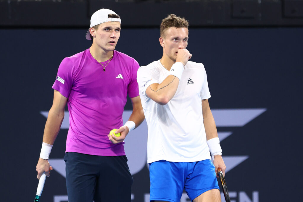 Jakub Mensik and Jiri Lehecka speaking during their doubles match at the 2025 Brisbane International.