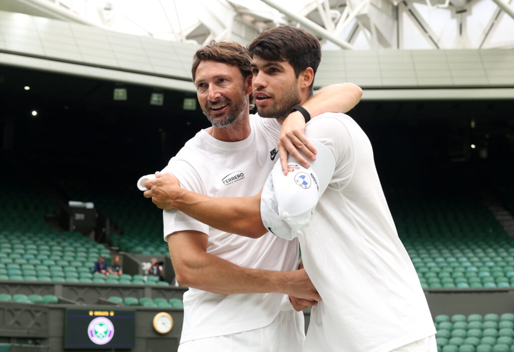Carlos Alcaraz and Juan Carlos Ferrero hug at Wimbledon in 2025