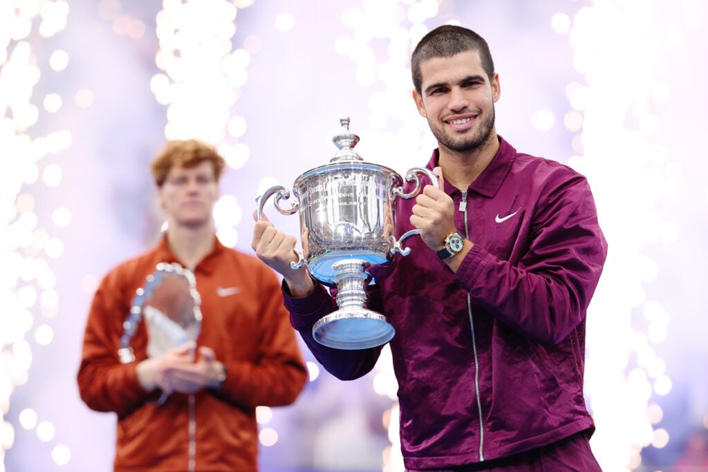 Jannik Sinner looks on as Carlos Alcaraz lifts the 2025 US Open title