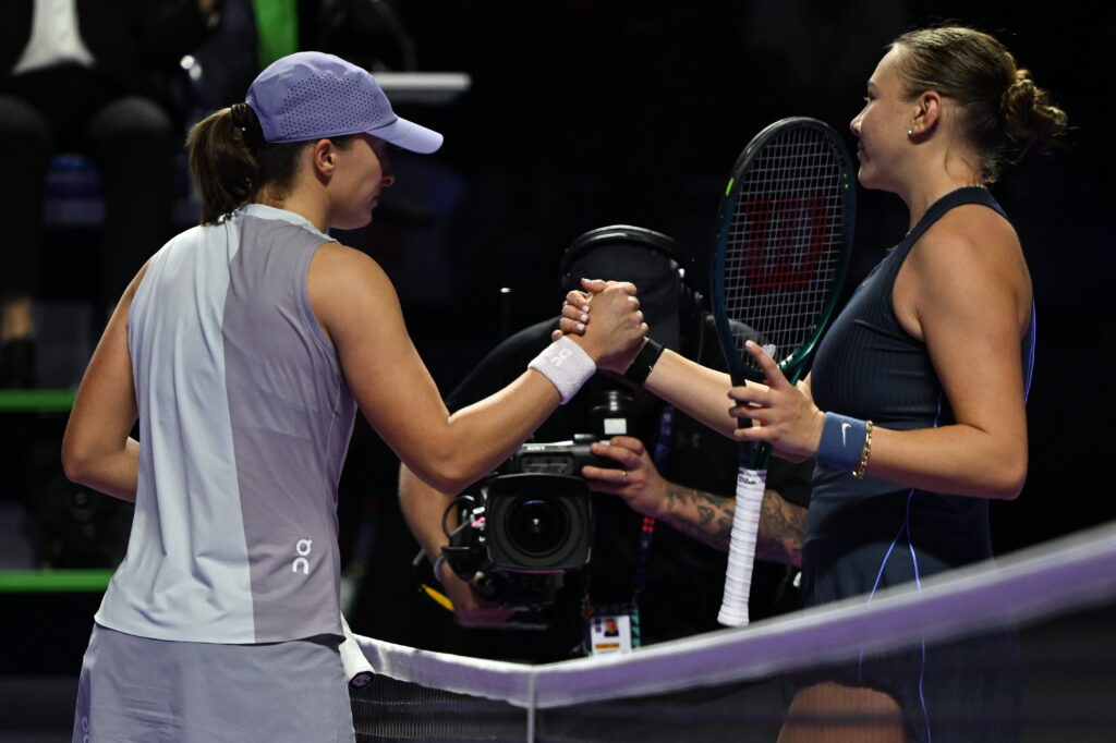 Iga Swiatek shakes hands with Amanda Anisimova after being beaten by the American at the 2025 WTA Finals in Riyadh, Saudi Arabia.