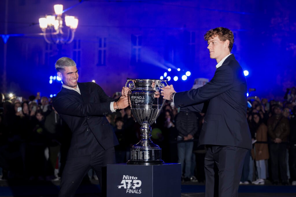 Carlos Alcaraz and Jannik Sinner tug either side of the year-end number one trophy