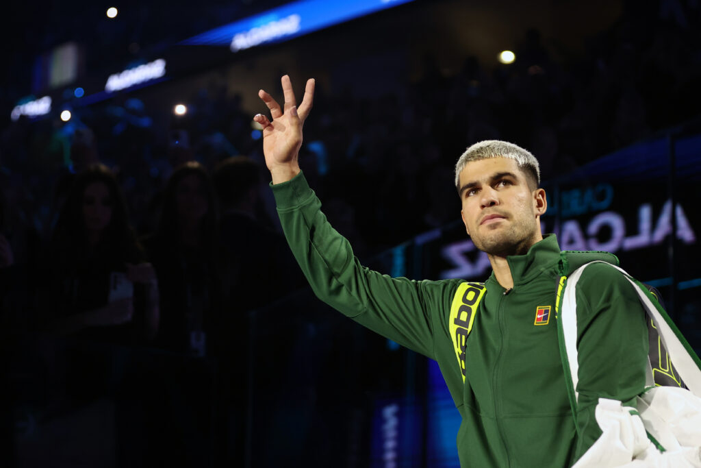 Carlos Alcaraz greets fans before his match against Alex de Minaur at the 2025 ATP Finals