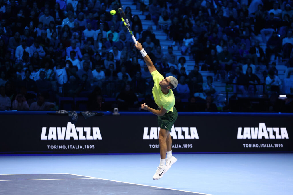 Carlos Alcaraz hits a serve.