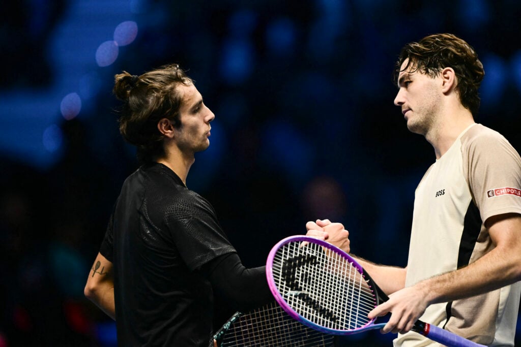 Taylor Fritz shakes hands with Lorenzo Musetti after beating him at the 2025 ATP Finals.