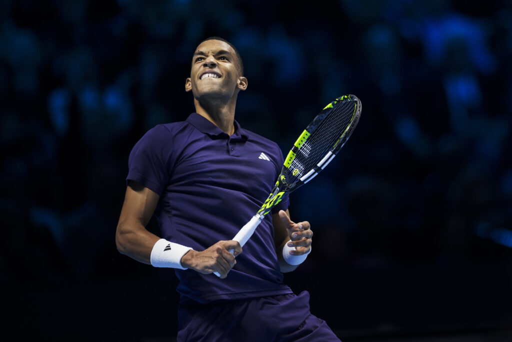Felix Auger-Aliassime grins and looks up after beating Ben Shelton