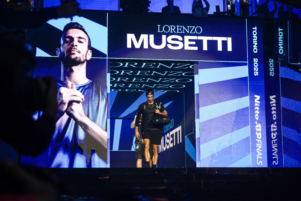 Lorenzo Musetti walks onto court to face Carlos Alcaraz