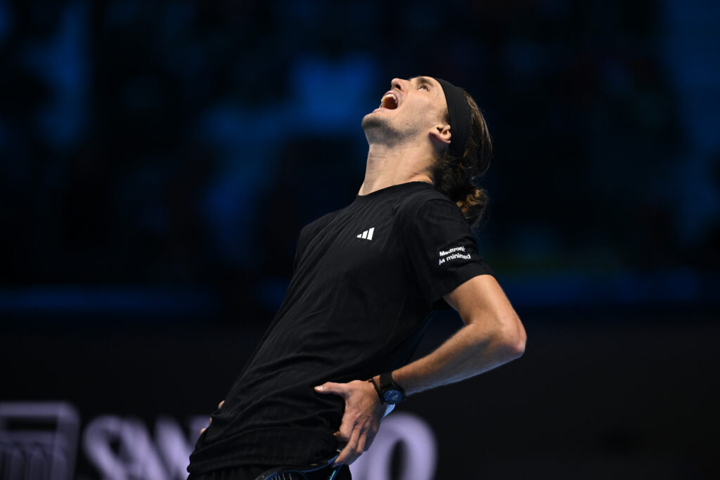 Alexander Zverev holds his lower back and shouts in frustration at the 2025 ATP Finals