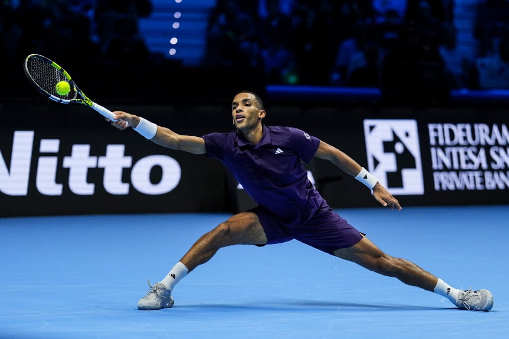 Felix Auger-Aliassime stretches to hit a forehand