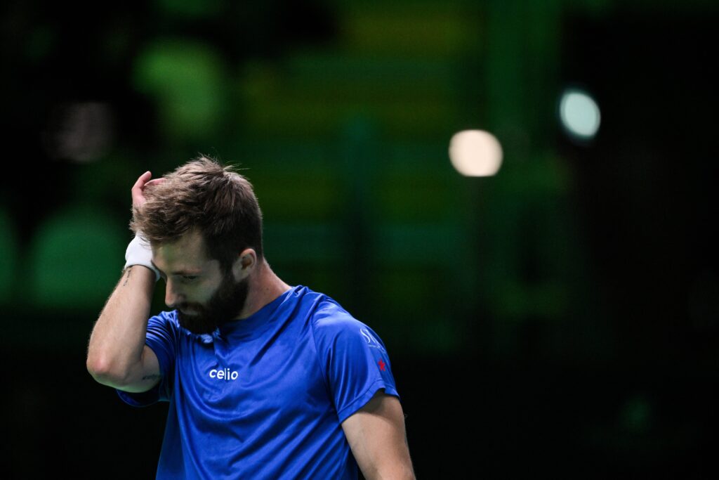 Corentin Moutet appears dejected during his match against Raphael Collignon at the 2025 Davis Cup Finals.