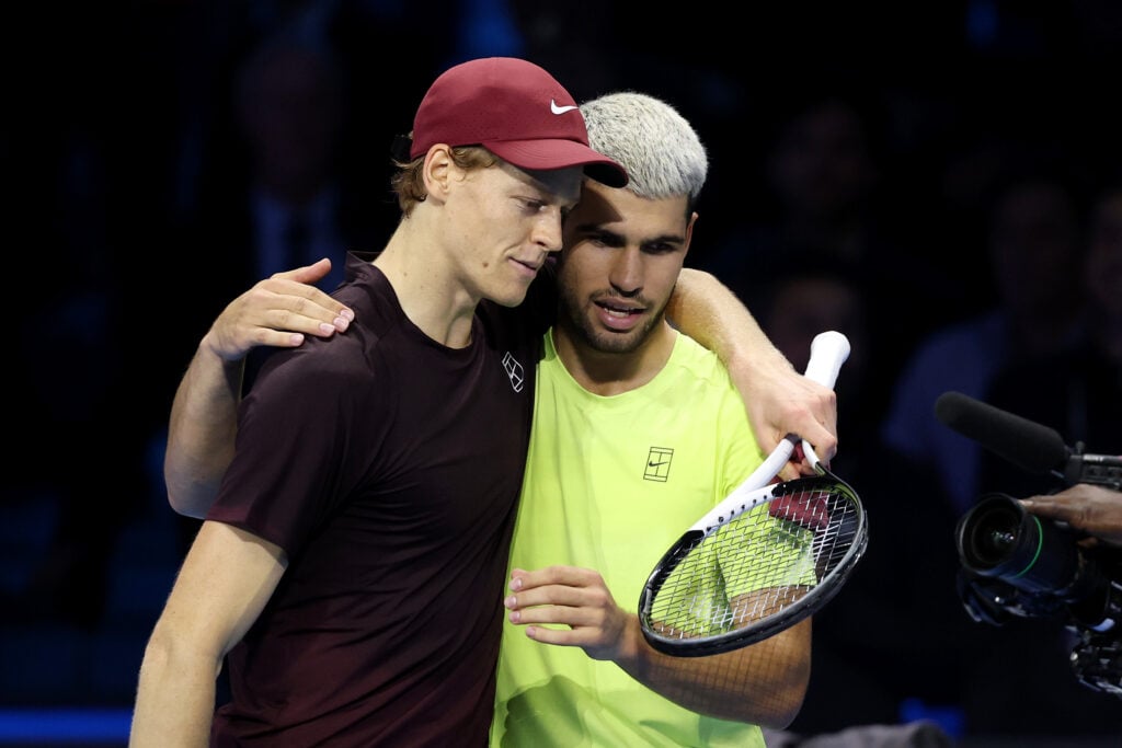 Jannik Sinner and Carlos Alcaraz embrace after their match at the 2025 ATP Finals