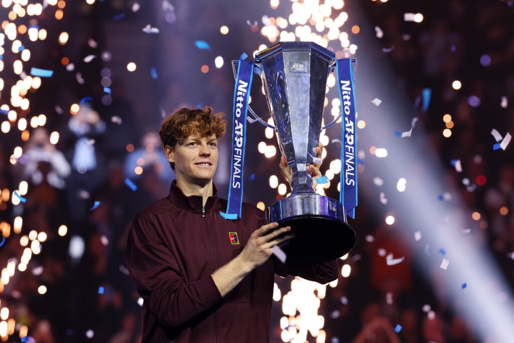 Jannik Sinner holding the ATP Finals trophy.