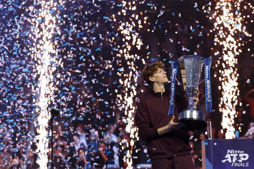 Jannik Sinner holding the 2025 ATP Finals title.