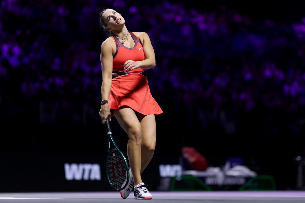 Aryna Sabalenka looks dejected on court
