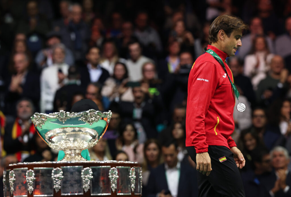 Spain's Davis Cup captain David Ferrer walks past trophy after losing in the 2025 final to Italy in Bologna.