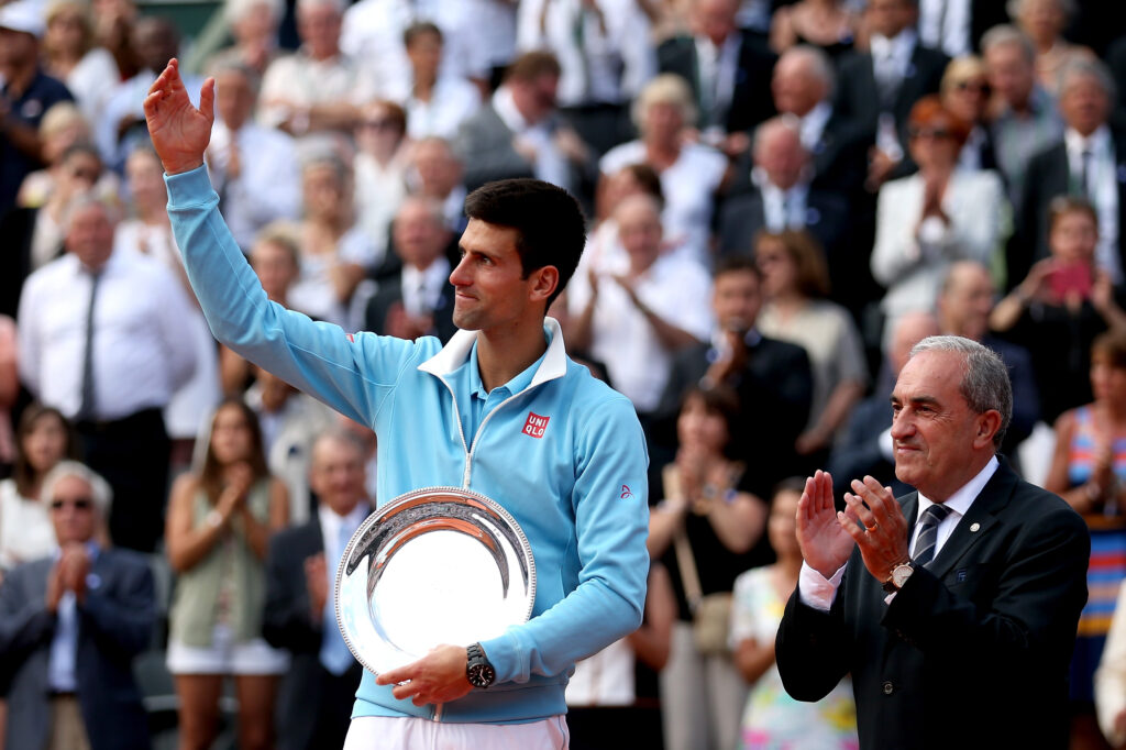 Novak Djokovic poses with the runner-up trophy after losing the 2014 French Open final to Rafael Nadal