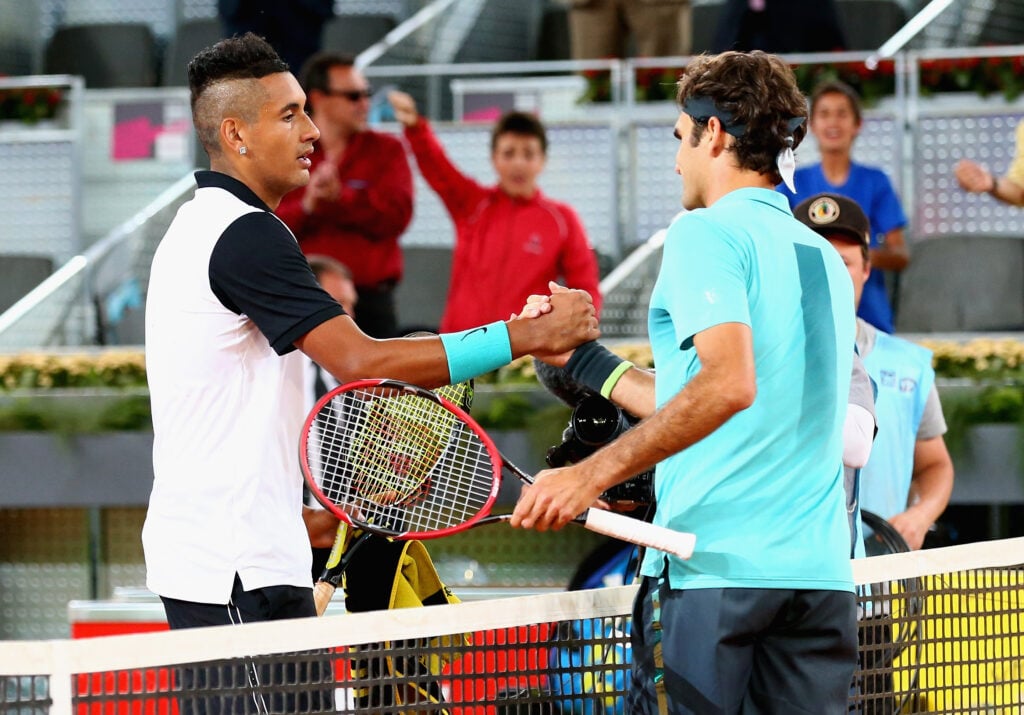 Nick Kyrgios and Roger Federer shake hands after playing each other at the Madrid Open in 2015.