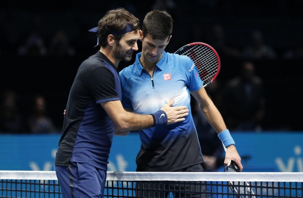 Novak Djokovic and Roger Federer embrace after the 2015 ATP Finals final.