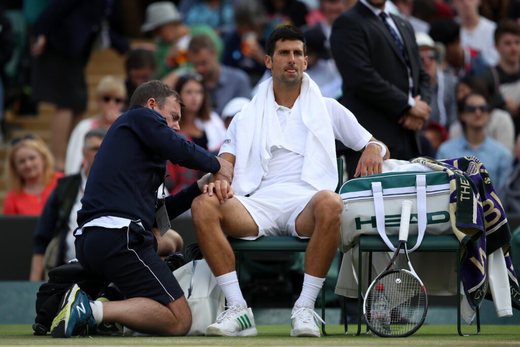 Novak Djokovic receives medical attention during his defeat to Tomas Berdych at Wimbledon in 2017