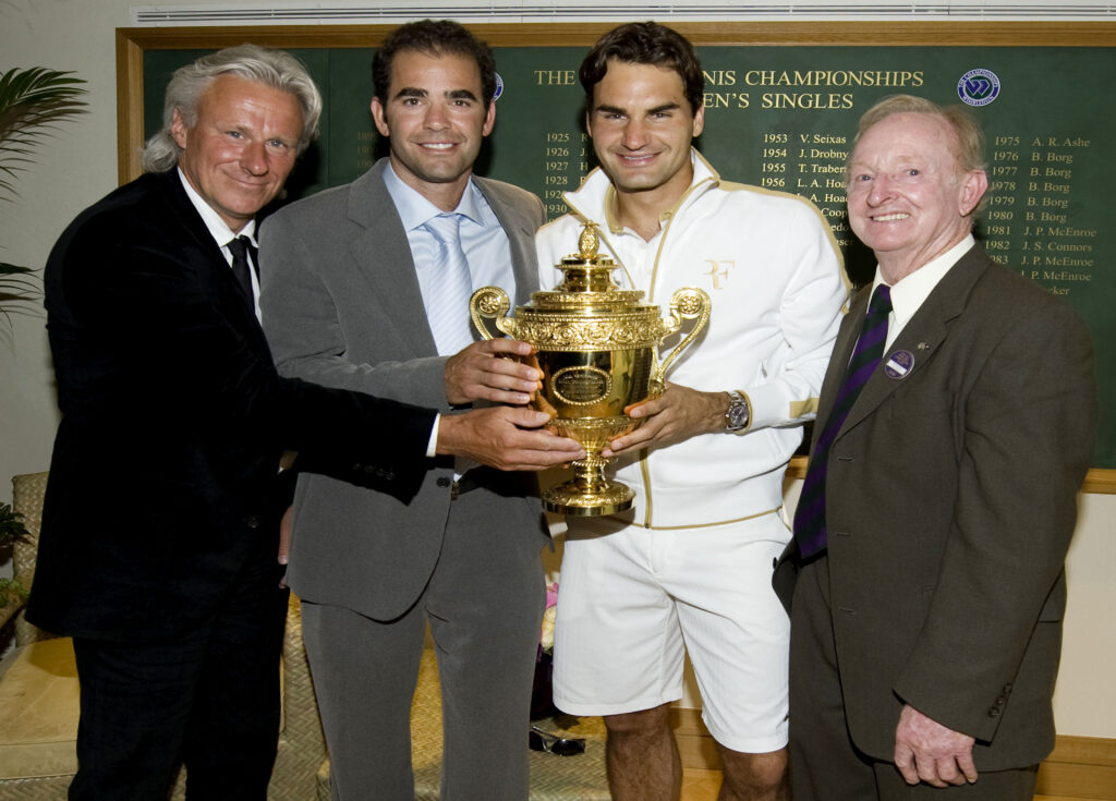 Bjorn Borg, Pete Sampras and Rod Laver celebrate with Roger Federer after he won Wimbledon in 2009