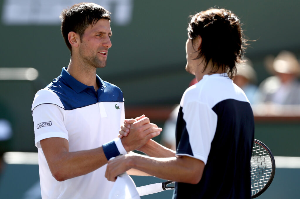 Novak Djokovic of Serbia congratulates Taro Daniel of Japan after their match during the BNP Paribas Open at the Indian Wells Tennis Garden.