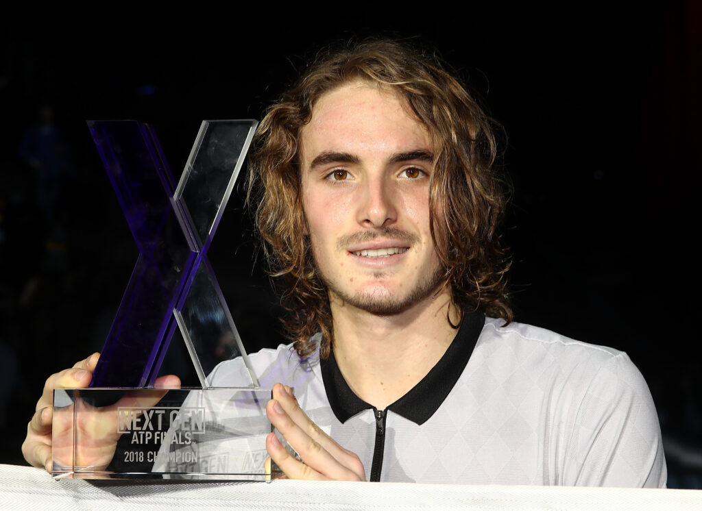Stefanos Tsitsipas holding the Next Gen ATP Finals trophy in 2018.