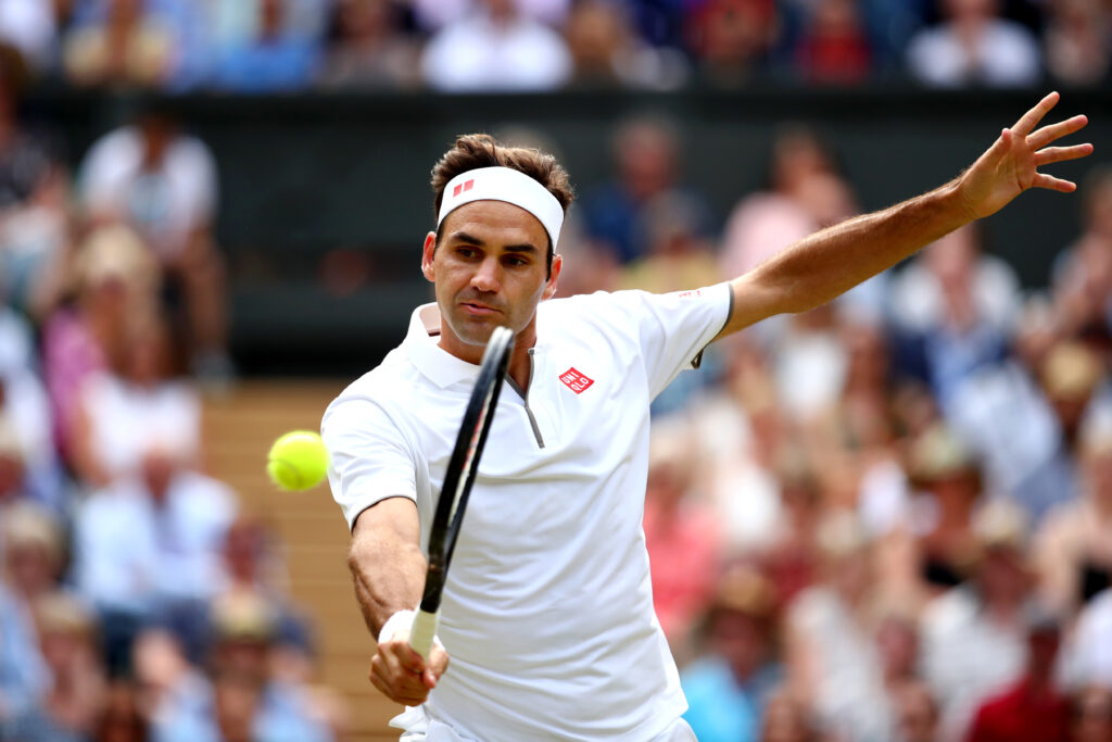 Roger Federer hits a backhand to Novak Djokovic in the 2019 Wimbledon final