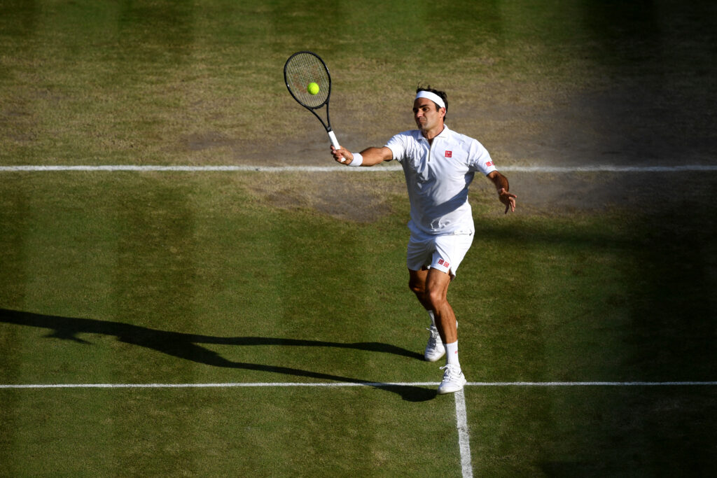 Roger Federer hitting a volley at Wimbledon in 2019.