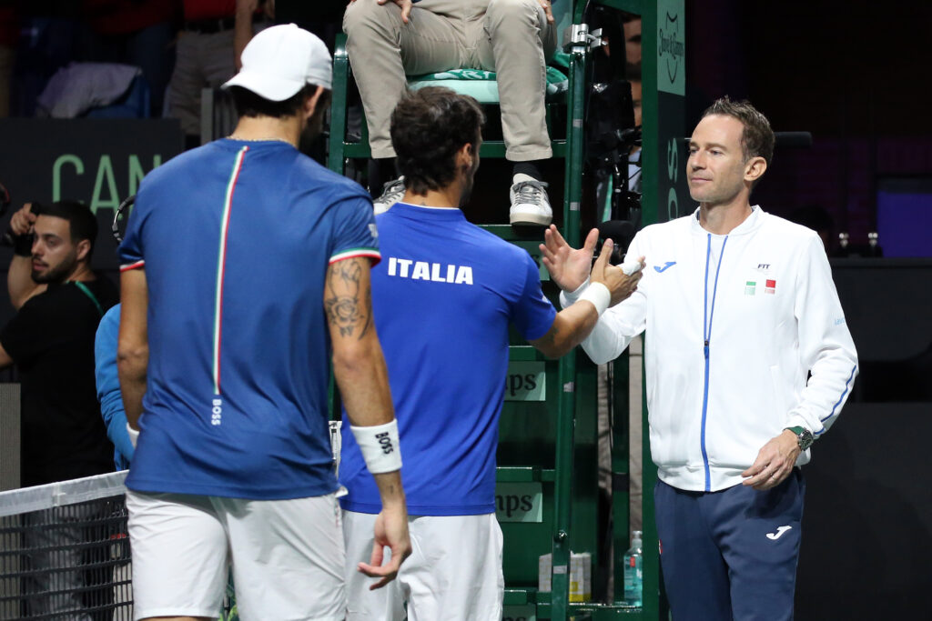 Fabio Fognini shakes hands with Italy Davis Cup captain Filippo Volandri after losing doubles match with Matteo Berrettini against Canada.
