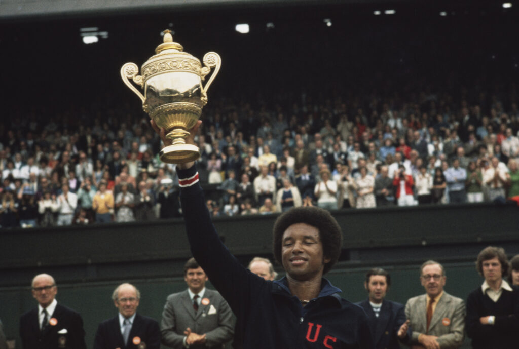 Arthur Ashe celebrates with the Wimbledon trophy in 1975