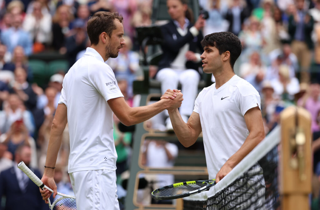 Carlos Alcaraz and Daniil Medvedev shake hands at the net after their Wimbledon semifinal match in 2024.
