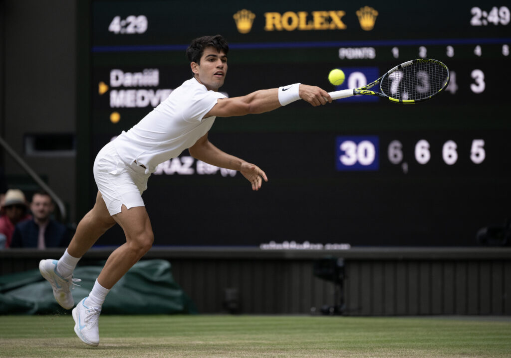 Carlos Alcaraz in action at Wimbledon in 2024.