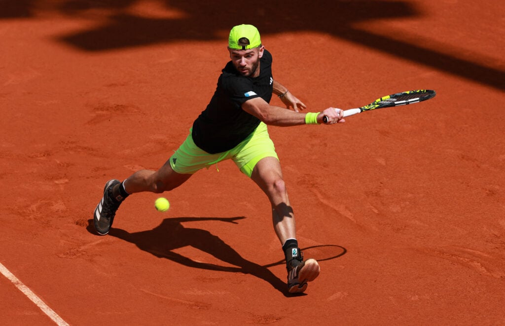 Jacob Fearnley of Great Britain plays a backhand against Tomas Machac of Czechia in the Men's Singles Second Round match during Day Five of the Mutua Madrid Open at La Caja Magica on April 26, 2025 in Madrid, Spain.