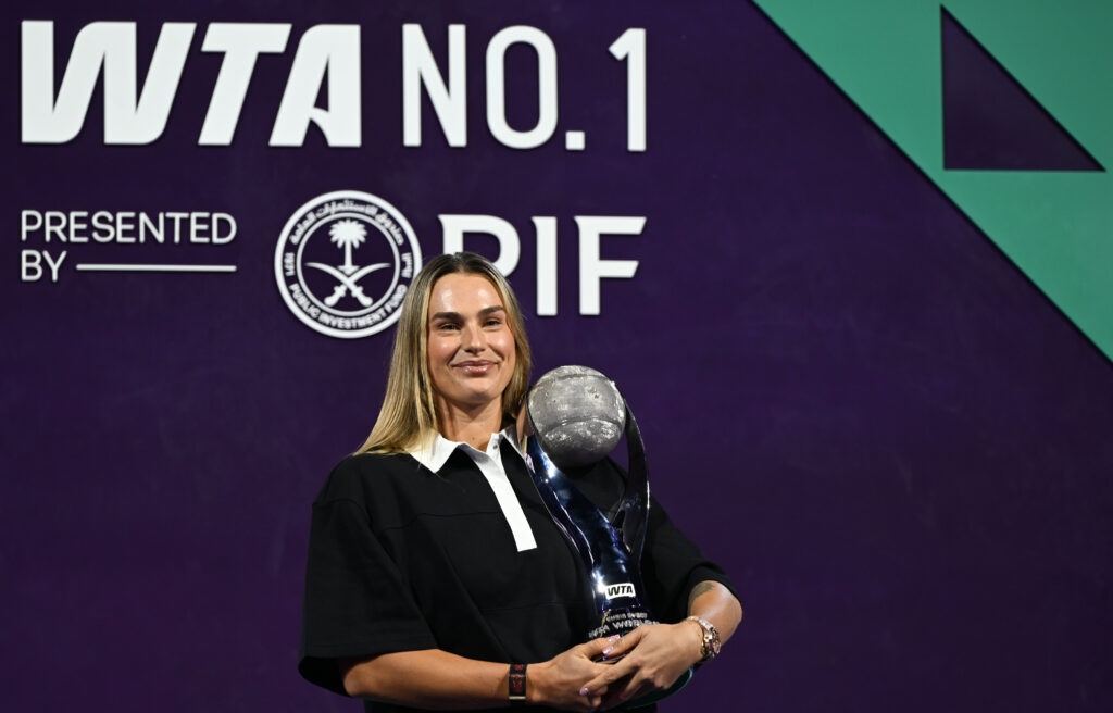 Aryna Sabalenka poses with year-end world number one trophy in Riyadh, Saudi Arabia.