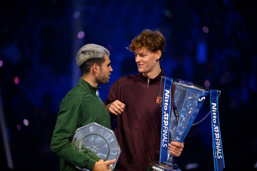 Carlos Alcaraz and Jannik Sinner hold their trophies after the 2025 ATP Finals final