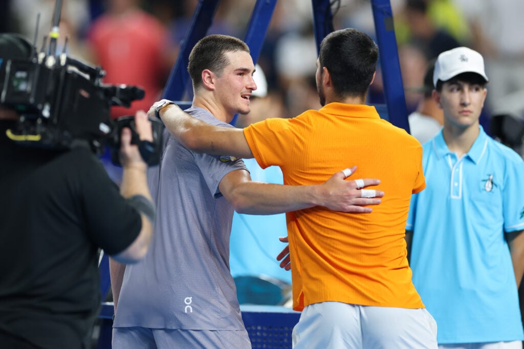 Joao Fonseca and Carlos Alcaraz embrace after their exhibition match in Miami.