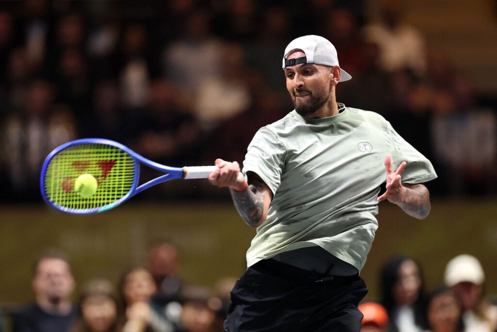 Australia's Nick Kyrgios hits a return against Belarus' Aryna Sabalenka during the Battle of the Sexes exhibition tennis match in Dubai on December 28, 2025.