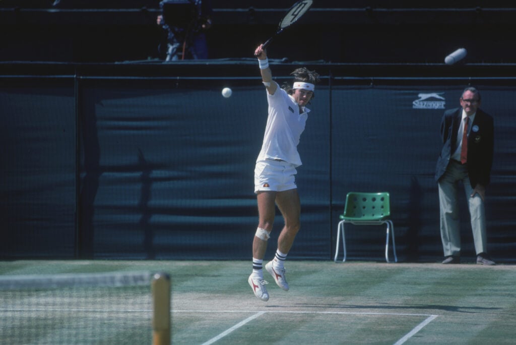 Chris Lewis hitting a backhand at Wimbledon in 1983.