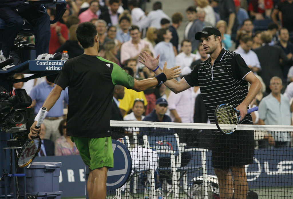 Andy Roddick and Novak Djokovic shake hands at the end of the match at the 2008 US Open.