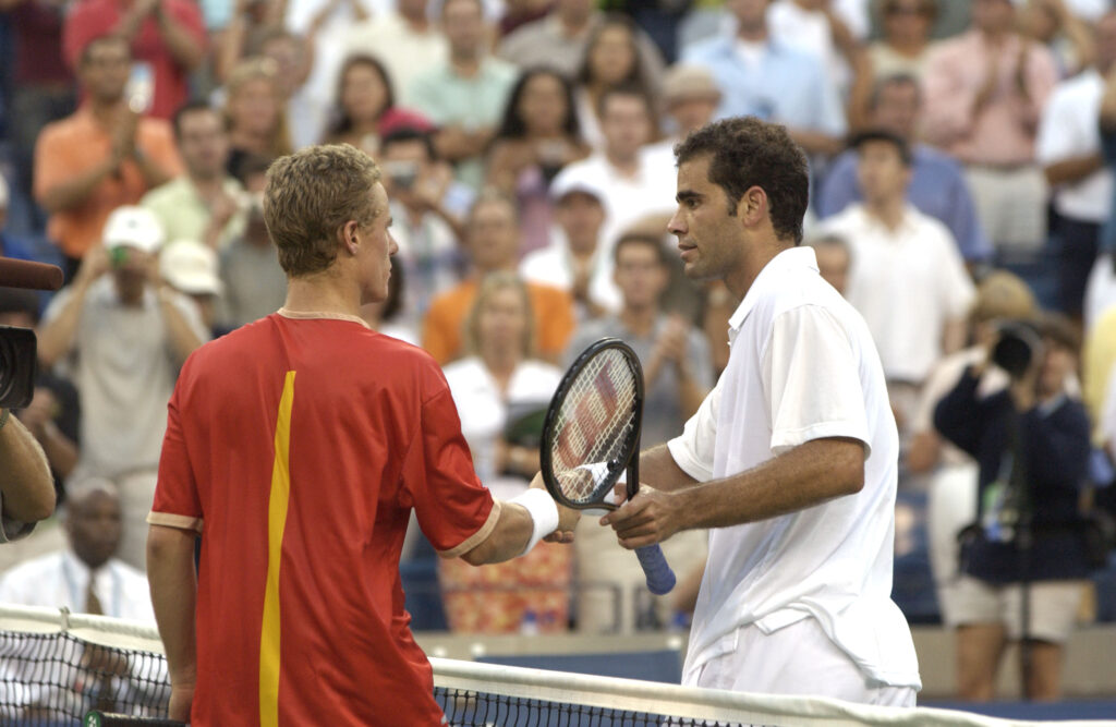 Pete Sampras and Lleyton Hewitt meet at the net at the US Open.